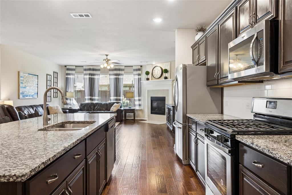 Kitchen with stainless steel appliances including a gas range.
