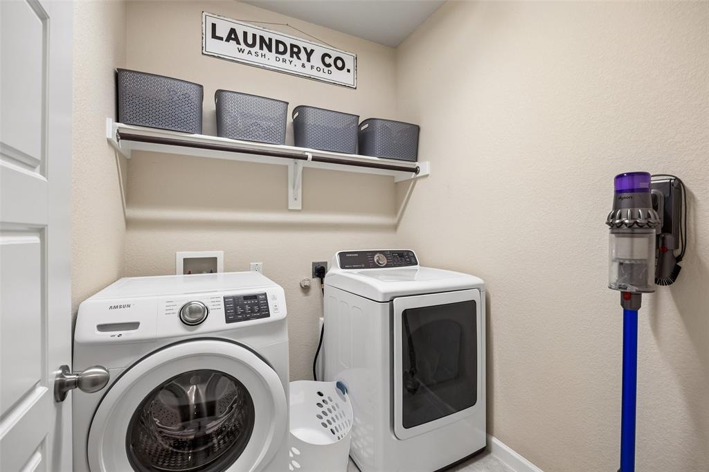 Laundry space featuring open storage shelves