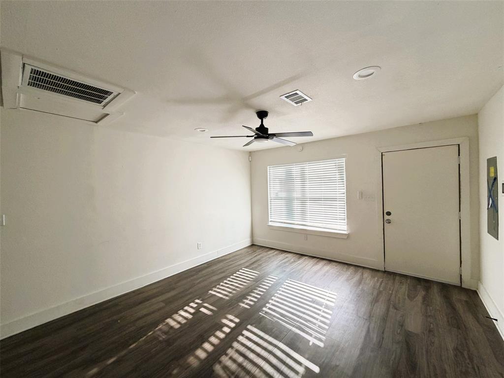 Living room with entry open to kitchen and dining.