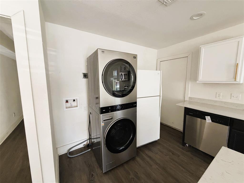 Laundry in kitchen with stackable and fridge