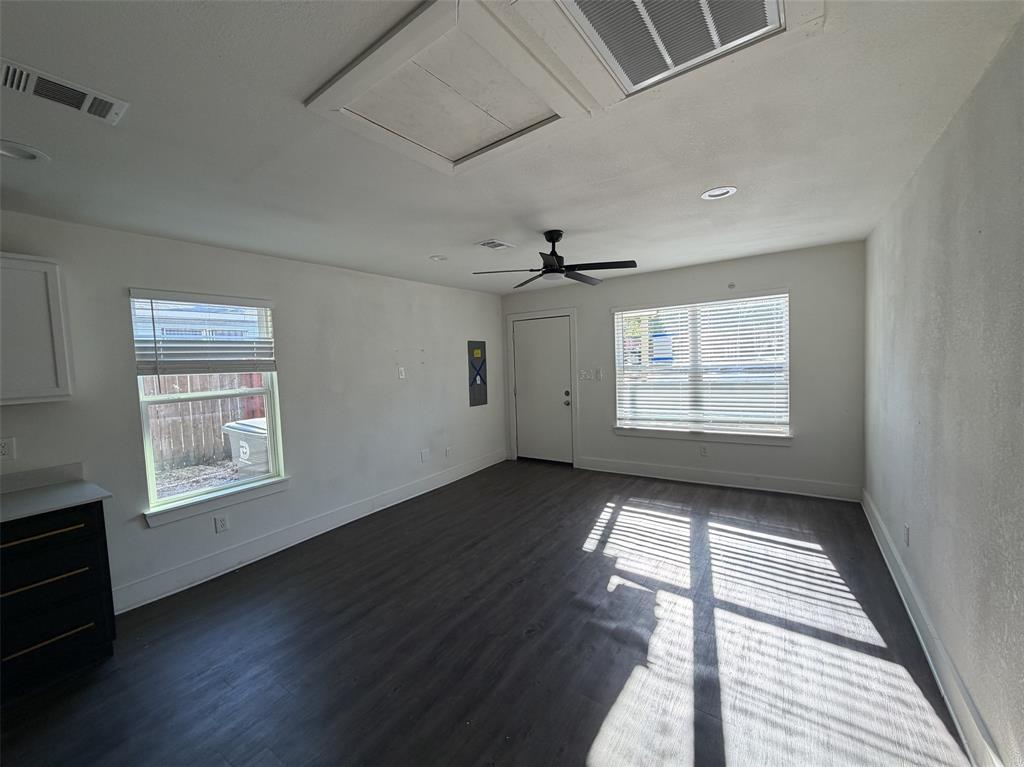 Living room with entry open to kitchen and dining.