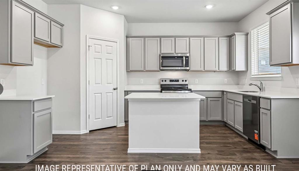 Kitchen featuring light gray shaker-style cabinetry, a central island, solid-surface countertops, wood-finish flooring, and stainless steel appliances