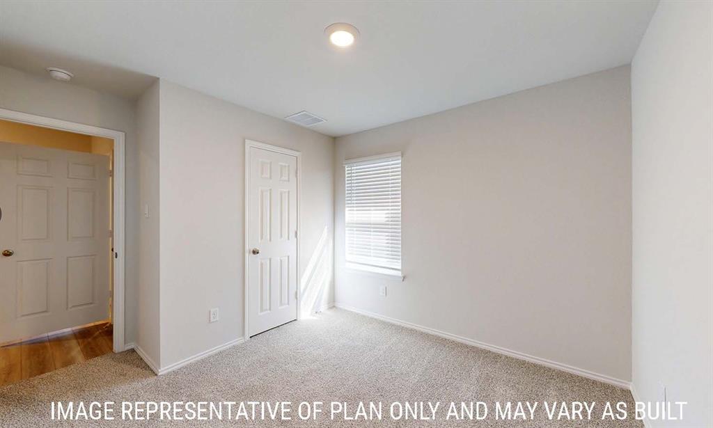 Neutral wall-toned room featuring carpeted flooring, a six-panel interior door, a single-hung window with horizontal blinds, and a flush-mount ceiling light fixture