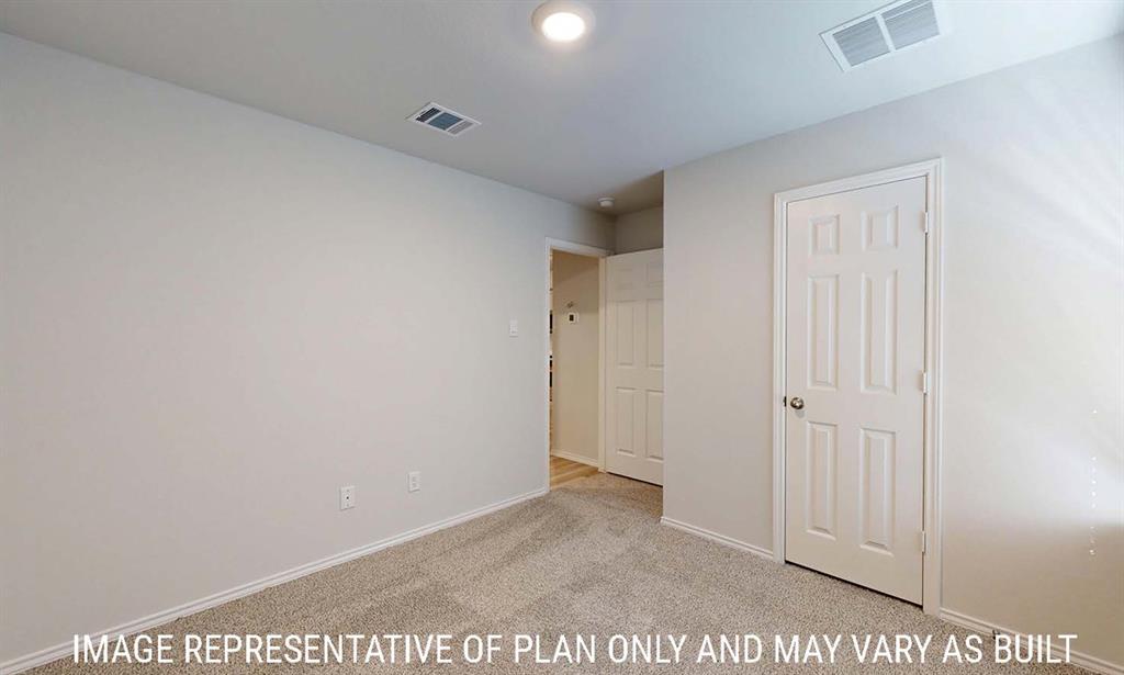 Neutral-toned interior featuring wall-to-wall carpeting, crisp white walls, and a six-panel interior door