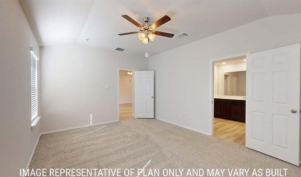 Vaulted ceiling with a central multi-blade ceiling fan, neutral wall-to-wall carpeting, and six-panel interior doors