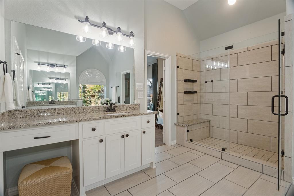Oversized shower with a built-in bench, and a makeup bench.