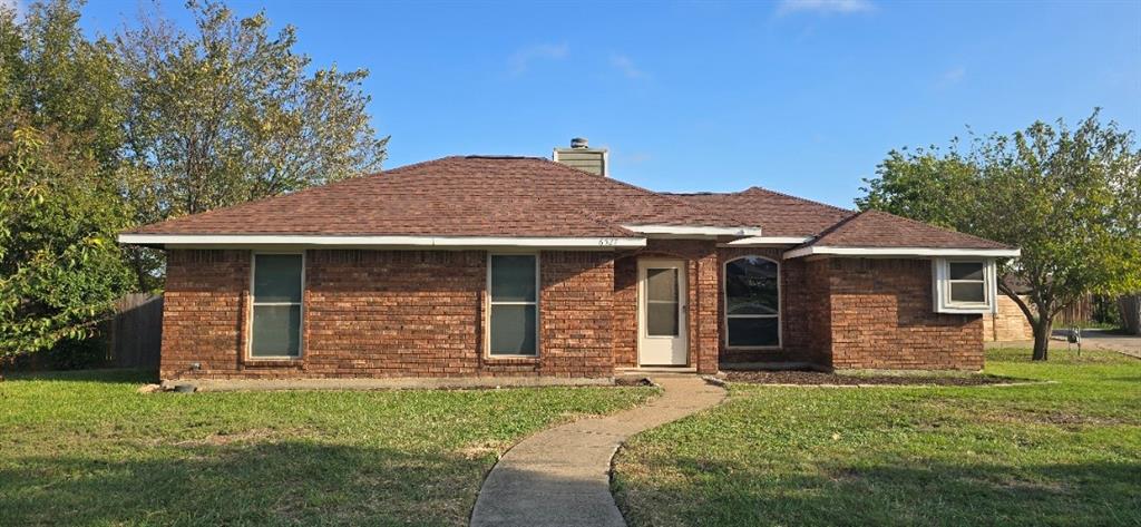 Single-story brick exterior featuring a hip roof, arched window, and concrete walkway