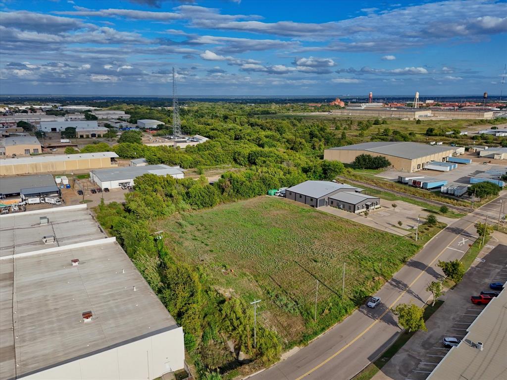 Cleared rectangular parcel featuring street-level accessibility and dense perimeter vegetation