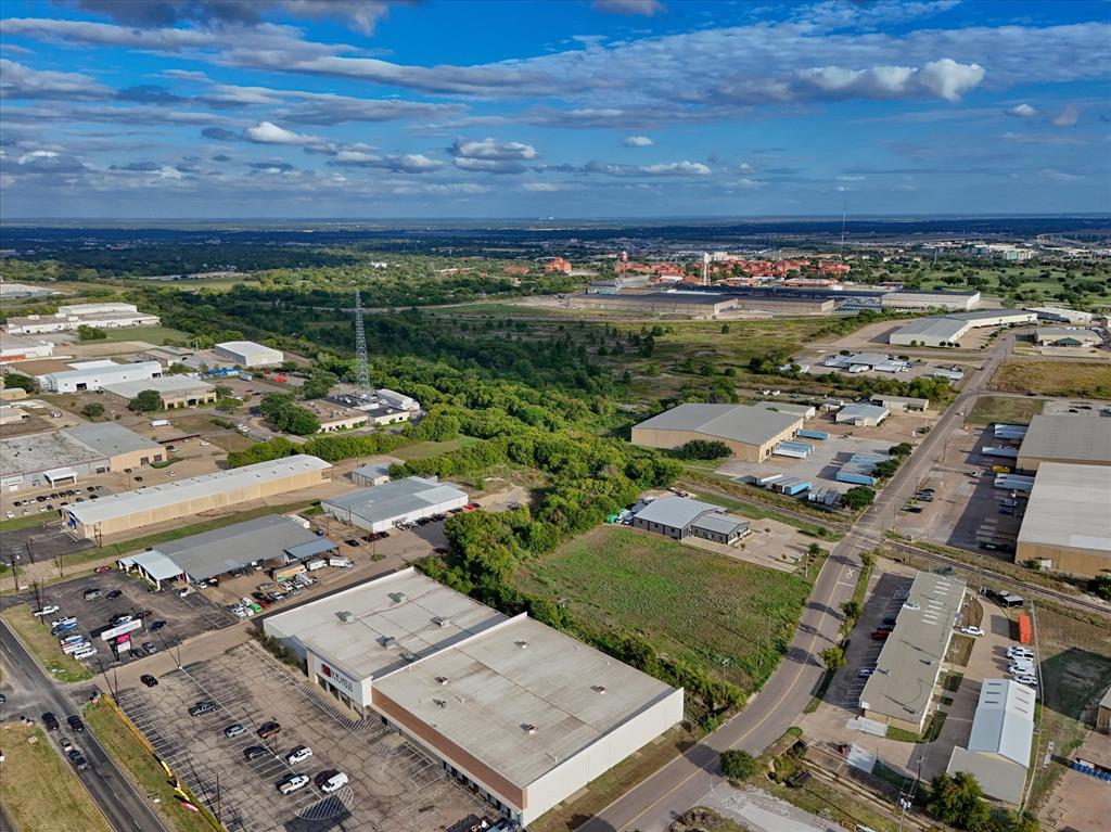 Industrial site featuring expansive warehouse structures, paved surface parking, dedicated loading docks, and direct access to municipal thoroughfares