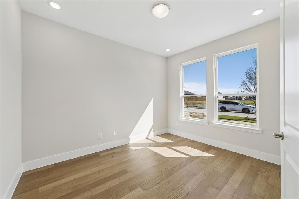 Neutral-toned interior featuring wood-finish flooring, recessed lighting, dual pane windows, and a flush-mount ceiling fixture