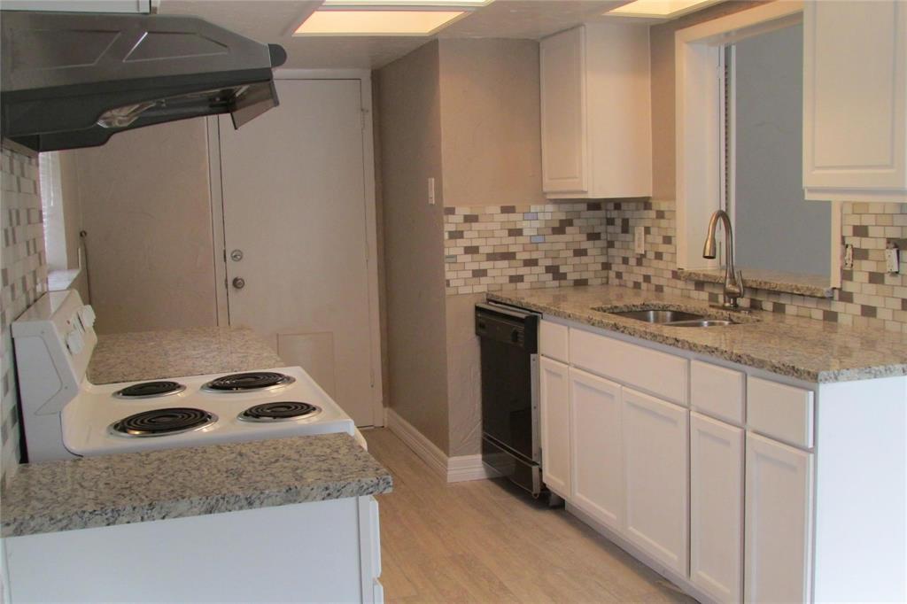 Kitchen featuring white cabinetry, stone-finish countertops, subway tile backsplash, recessed lighting, and a stainless steel high-arch faucet