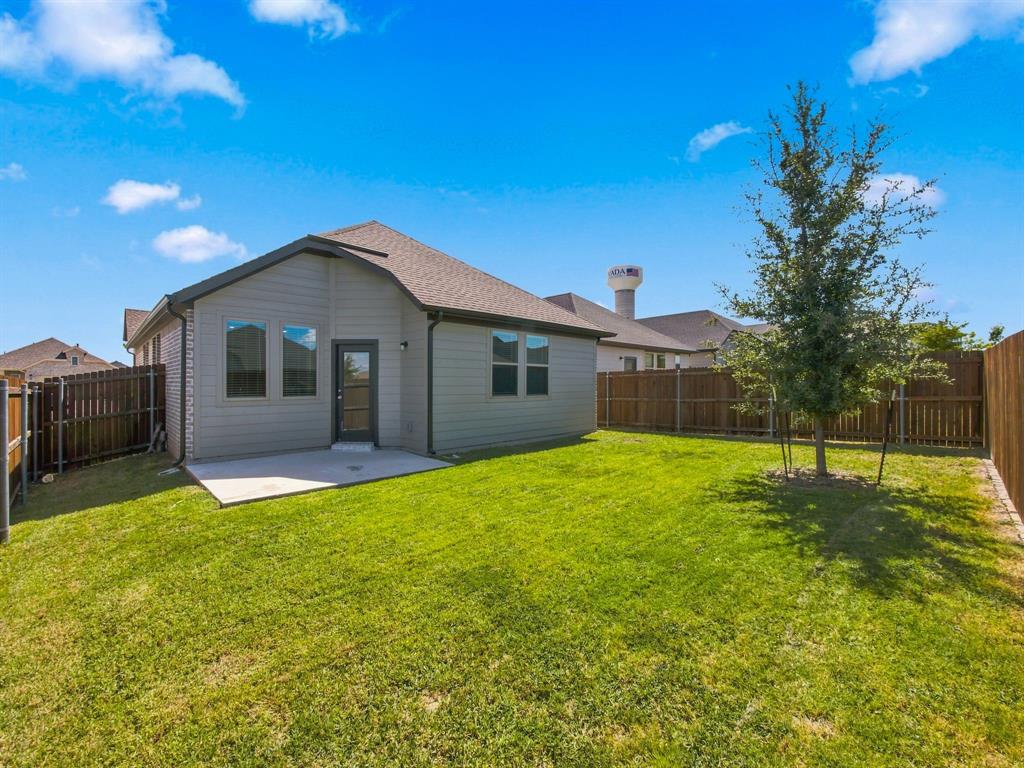 Rear exterior featuring horizontal lap siding, a concrete patio, and a fully enclosed backyard with wood privacy fencing