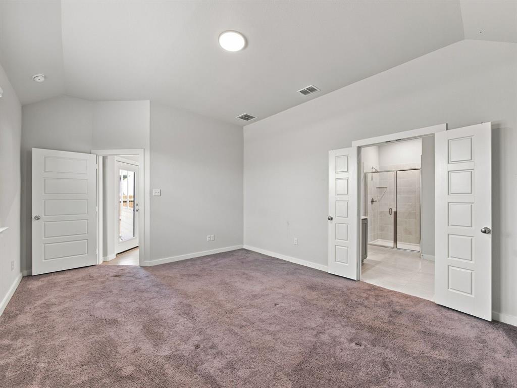 Vaulted ceiling, plush carpeting, five-panel interior doors, and a glass-enclosed shower stall