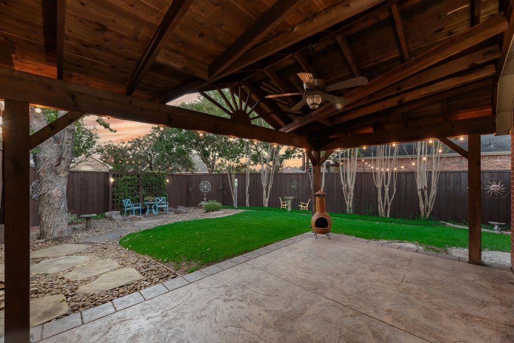Amazing back yard and patio with stamped concrete, custom patio cover with TV connections and ceiling fan. Privacy fence, mature trees.