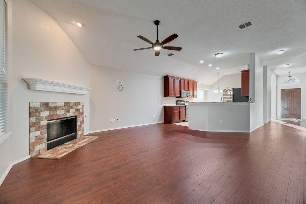 Family room with gas fireplace and gas logs. Naturally flows to kitchen and entry.