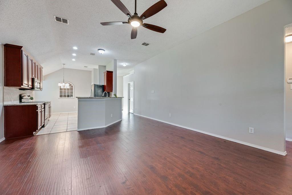 View from family room to kitchen. Primary bedroom suite to the right.