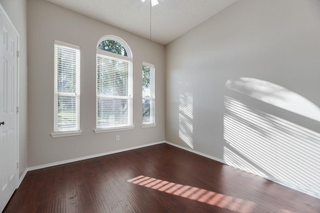 Bedroom with ceiling fan and closet.