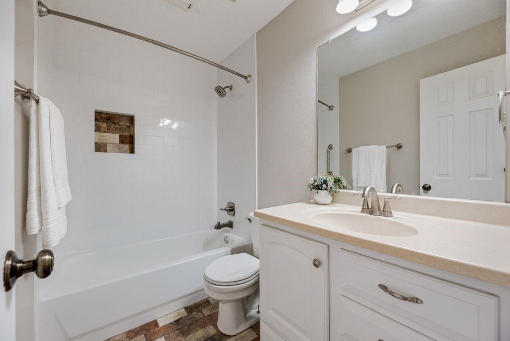 Updated secondary bathroom. New cabinets, tile and fixtures.
