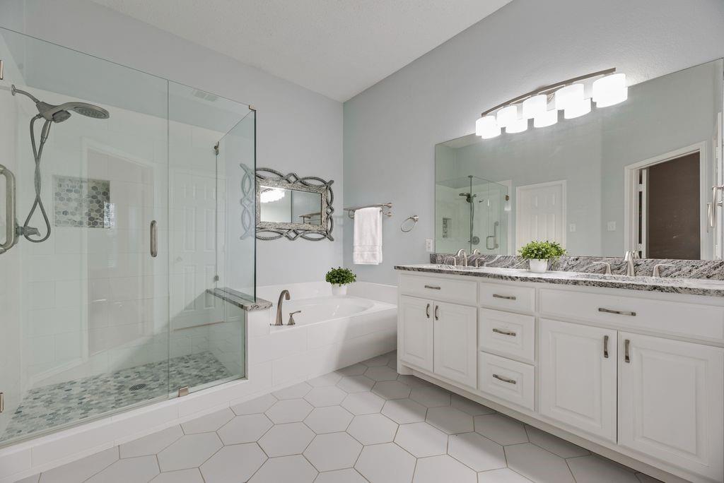 Beautifully updated primary bath with dual sinks, new cabinets and counter tops.