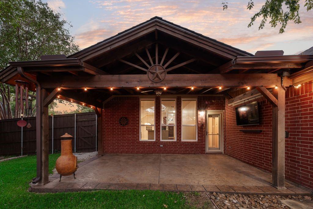 Beautiful back yard oasis. Covered patio, new windows and doors, stamped concrete, lush landscaping.