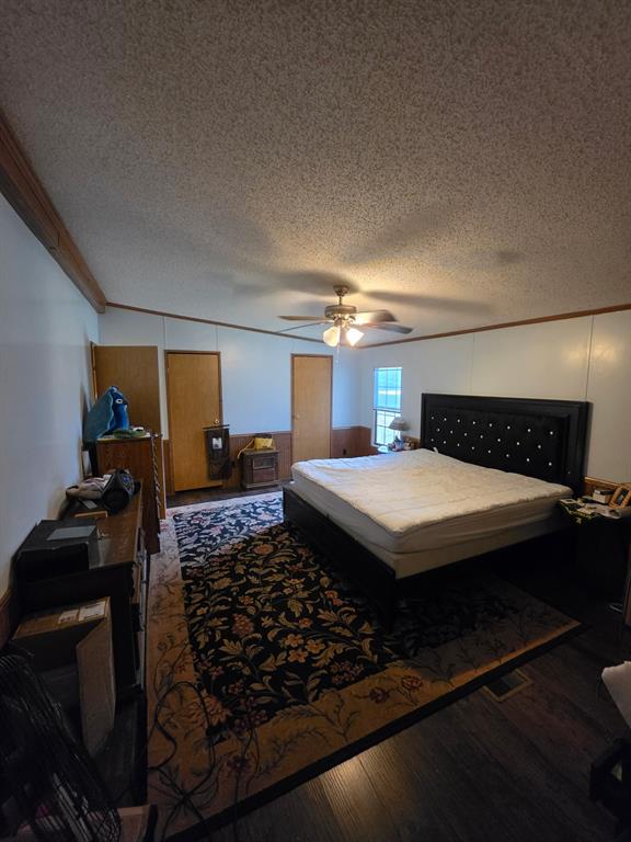 Vaulted ceiling featuring a central light fixture with an integrated ceiling fan, wood-finish flooring, and wood-trim accents Vaulted ceiling featuring a central light fixture with an integrated ceiling fan, wood-finish flooring, and wood-trim accents