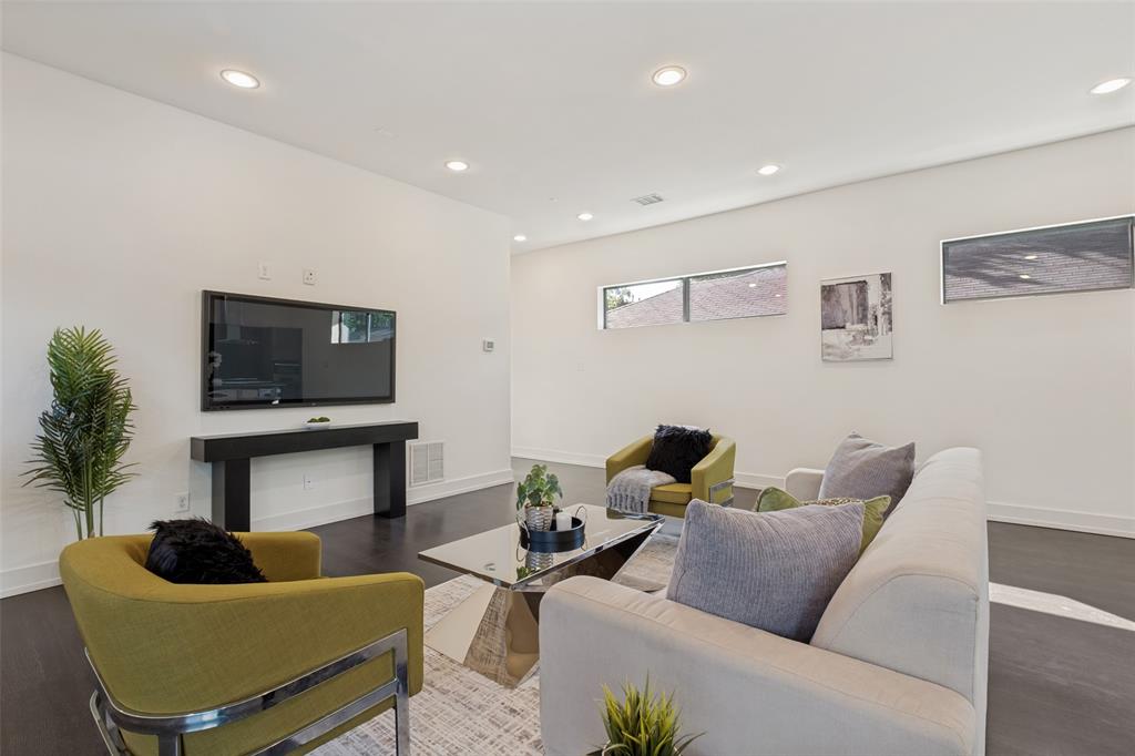 Spacious interior featuring dark wood-finish flooring, recessed lighting, and horizontal clerestory windows
