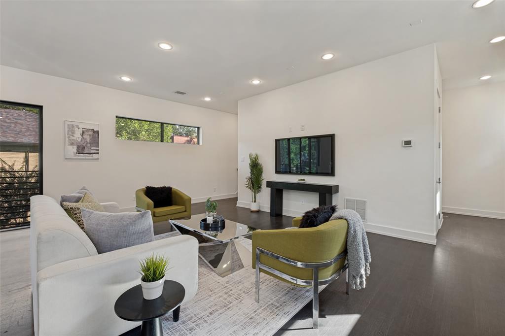 Open-concept living space featuring wood-finish flooring, recessed lighting, and clerestory windows