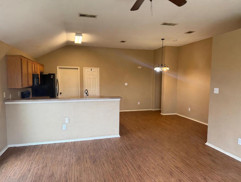 Vaulted ceilings, wood-finish flooring, breakfast bar, and multi-light chandelier Vaulted ceilings, wood-finish flooring, breakfast bar, and multi-light chandelier
