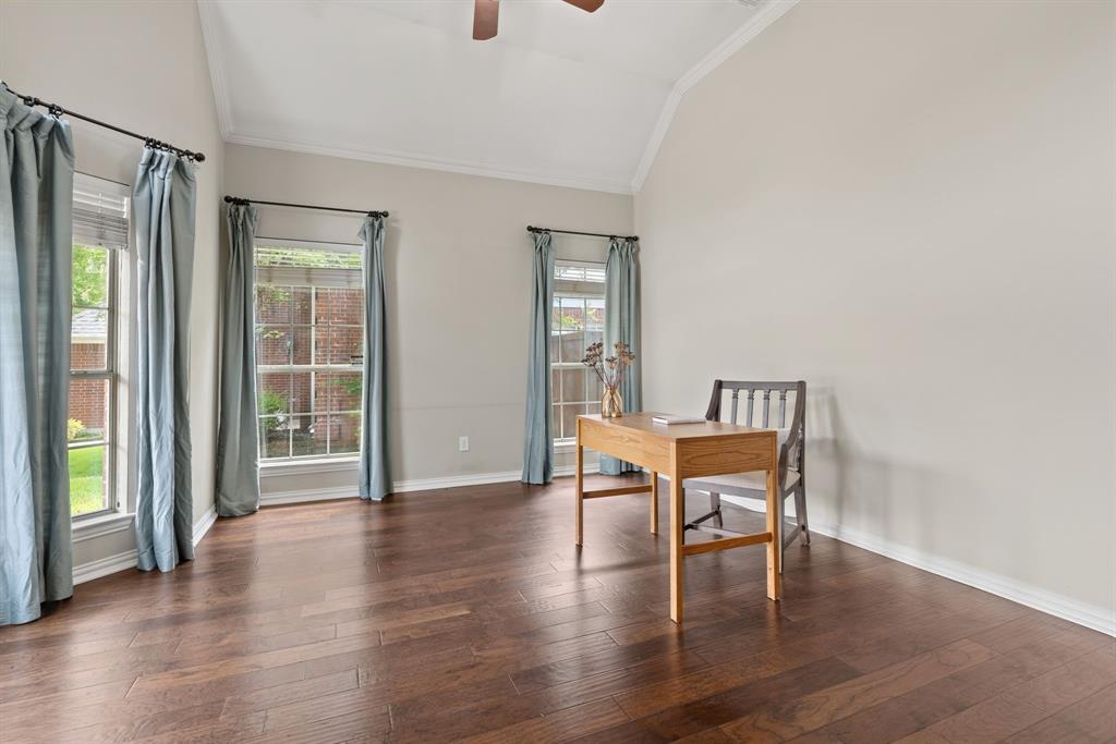Vaulted ceiling, wood-finish flooring, and multiple tall windows with integrated curtain rods Vaulted ceiling, wood-finish flooring, and multiple tall windows with integrated curtain rods