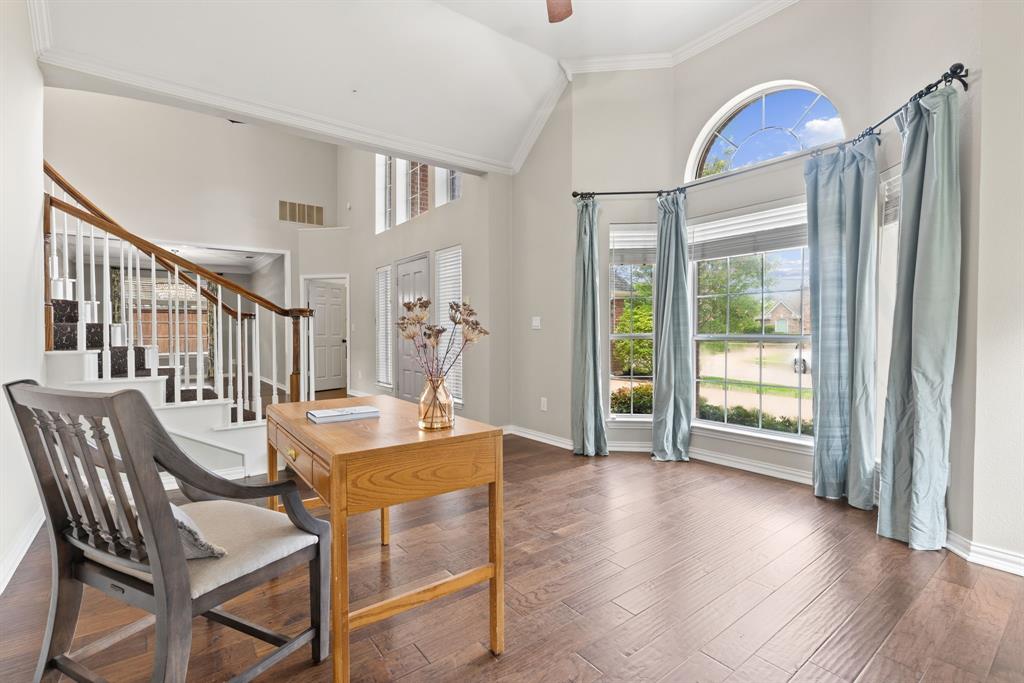 Vaulted ceilings, wood-finish flooring, staircase with wood handrail, and arched window bay Vaulted ceilings, wood-finish flooring, staircase with wood handrail, and arched window bay