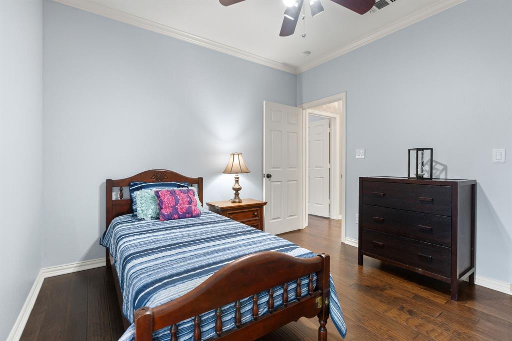 Wood-finish flooring, crown molding, and ceiling fan with integrated lighting