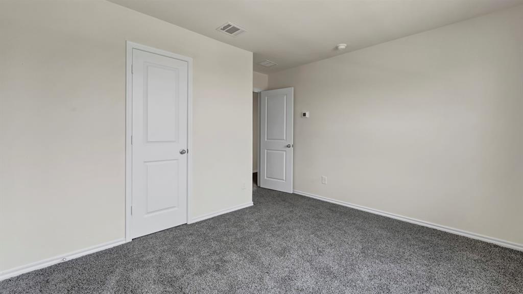 Neutral wall finishes, gray carpeting, and white interior doors