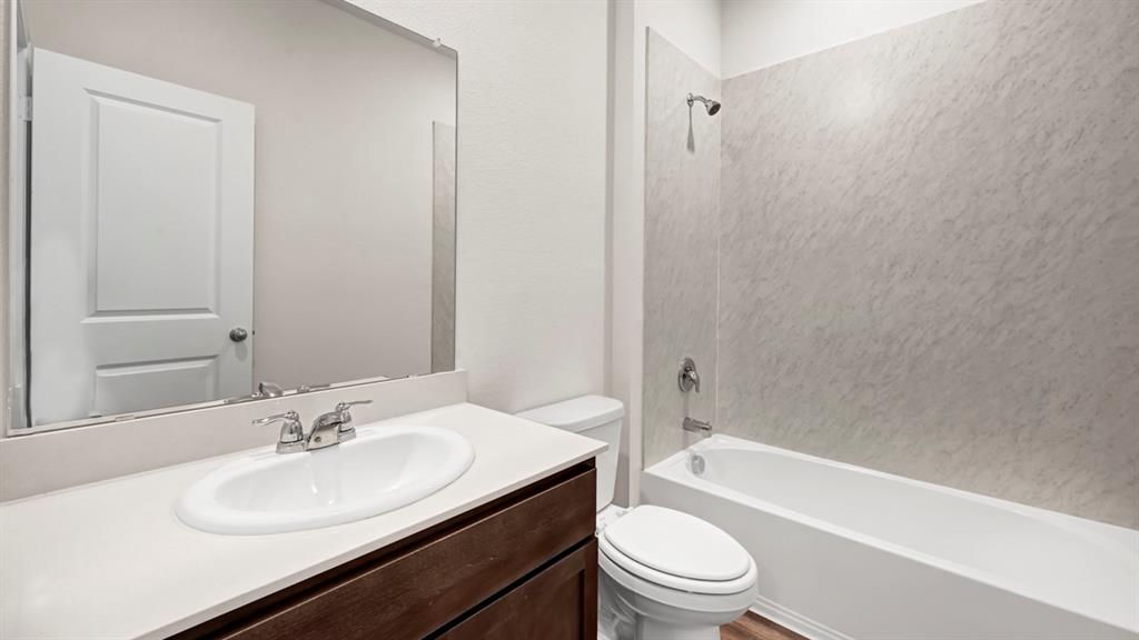 Built-in vanity with an undermount sink, chrome faucet, and integrated countertop Built-in vanity with an undermount sink, chrome faucet, and integrated countertop