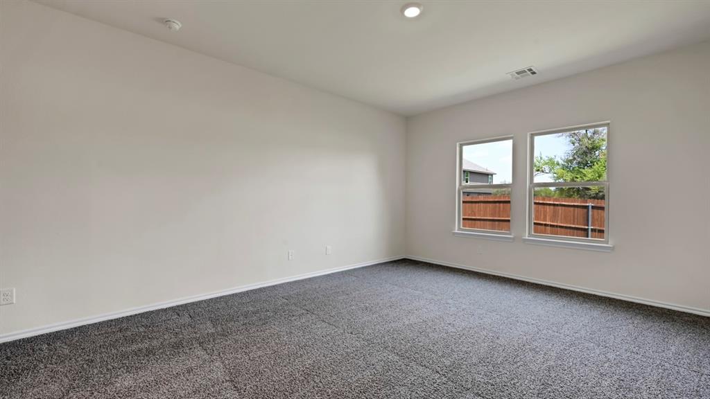 Neutral wall tones, gray carpet flooring, recessed ceiling lighting, and dual windows