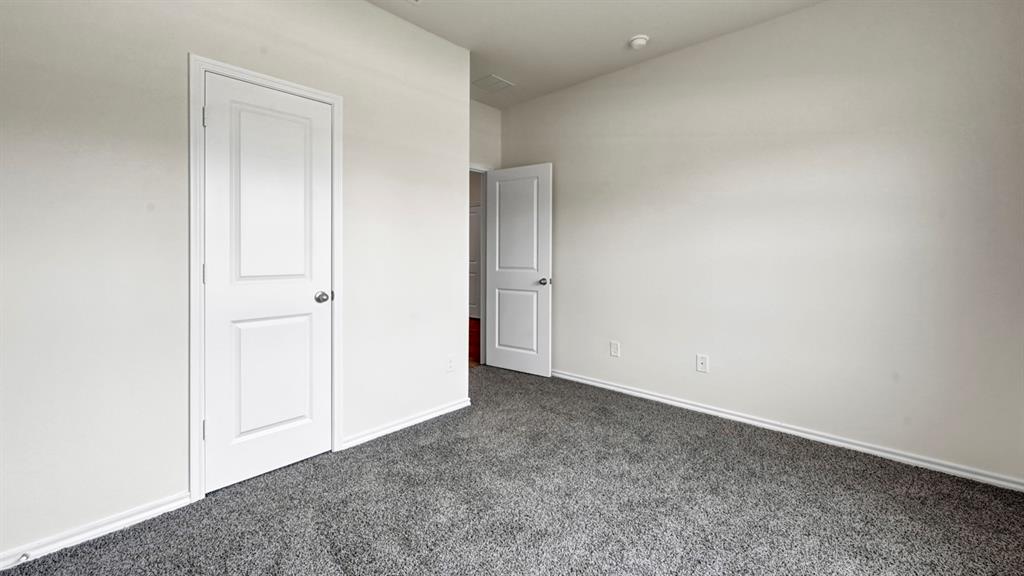 White interior walls, gray textured carpeting, and white interior doors White interior walls, gray textured carpeting, and white interior doors