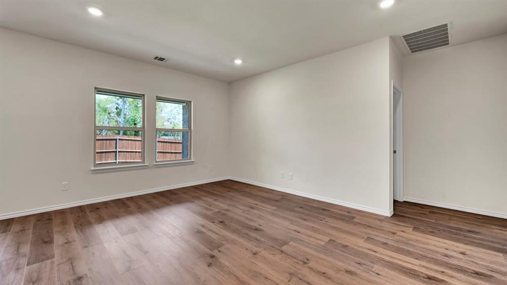 Wood-finish flooring, recessed lighting, and white walls with white trim