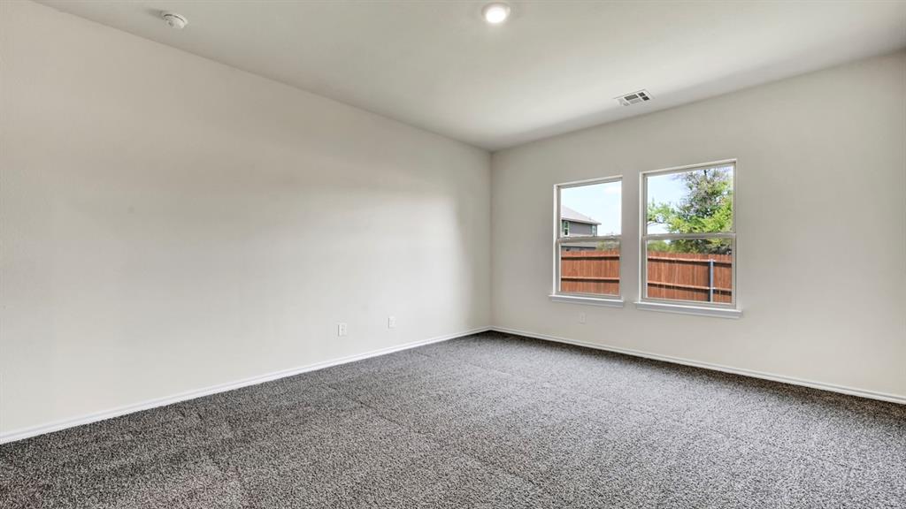 Recessed lighting, light gray carpet, and two double-hung windows Recessed lighting, light gray carpet, and two double-hung windows