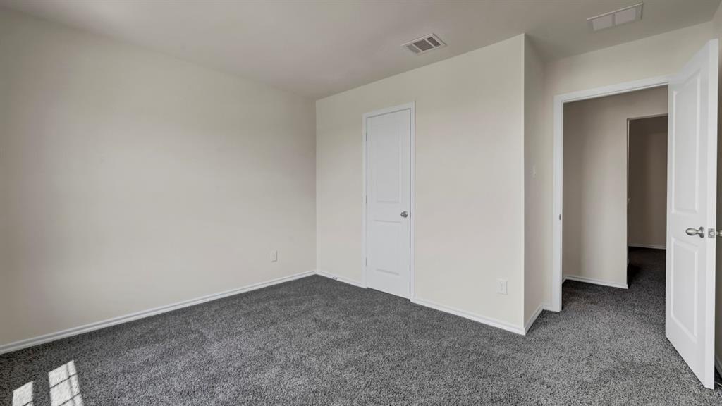Neutral color palette, gray carpet flooring, white interior doors, and recessed ceiling vents