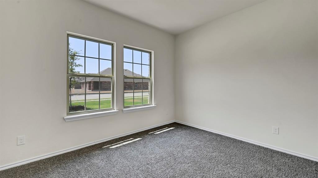 Dual pane windows, white wall finishes, and dark gray carpeting Dual pane windows, white wall finishes, and dark gray carpeting
