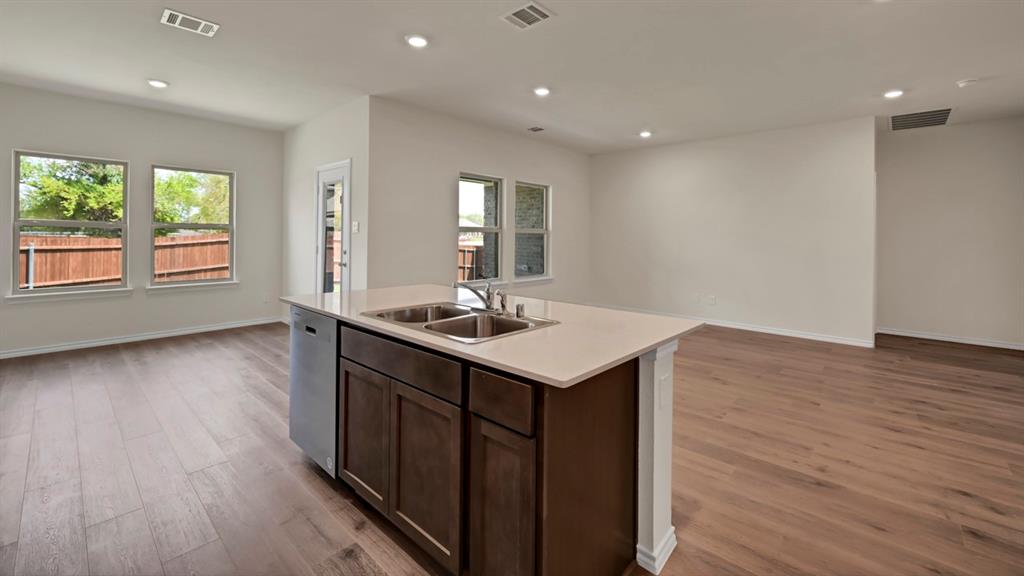 Kitchen island with a double basin sink and a built-in dishwasher