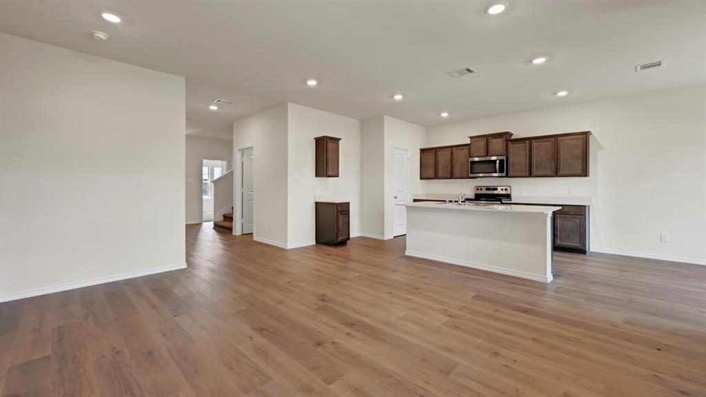 Open-concept space featuring wood-finish flooring and recessed lighting