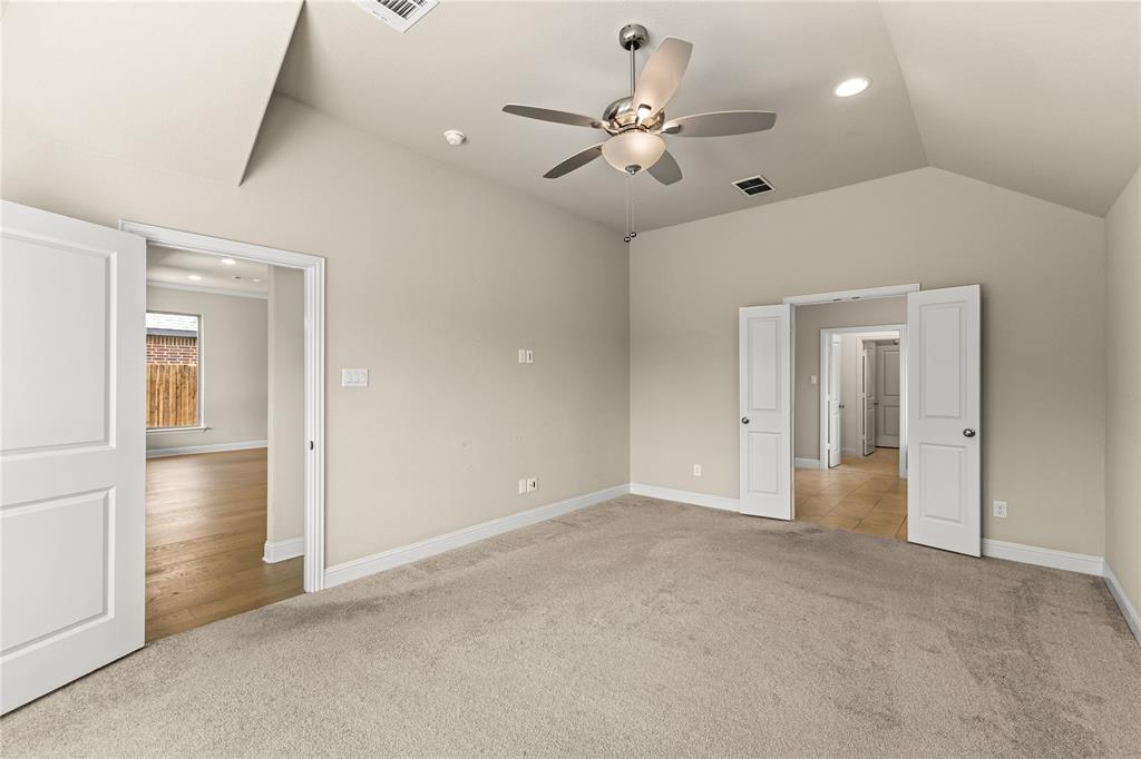 Vaulted ceiling featuring a central multi-blade ceiling fan with integrated lighting and recessed ceiling lights