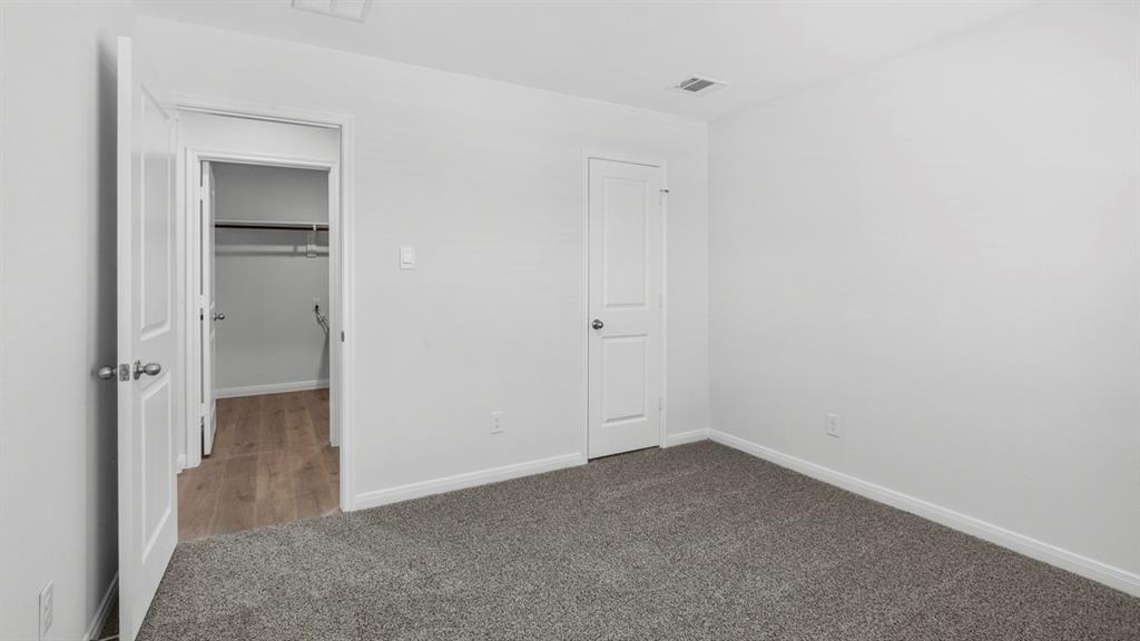 Carpeted room with white walls and trim