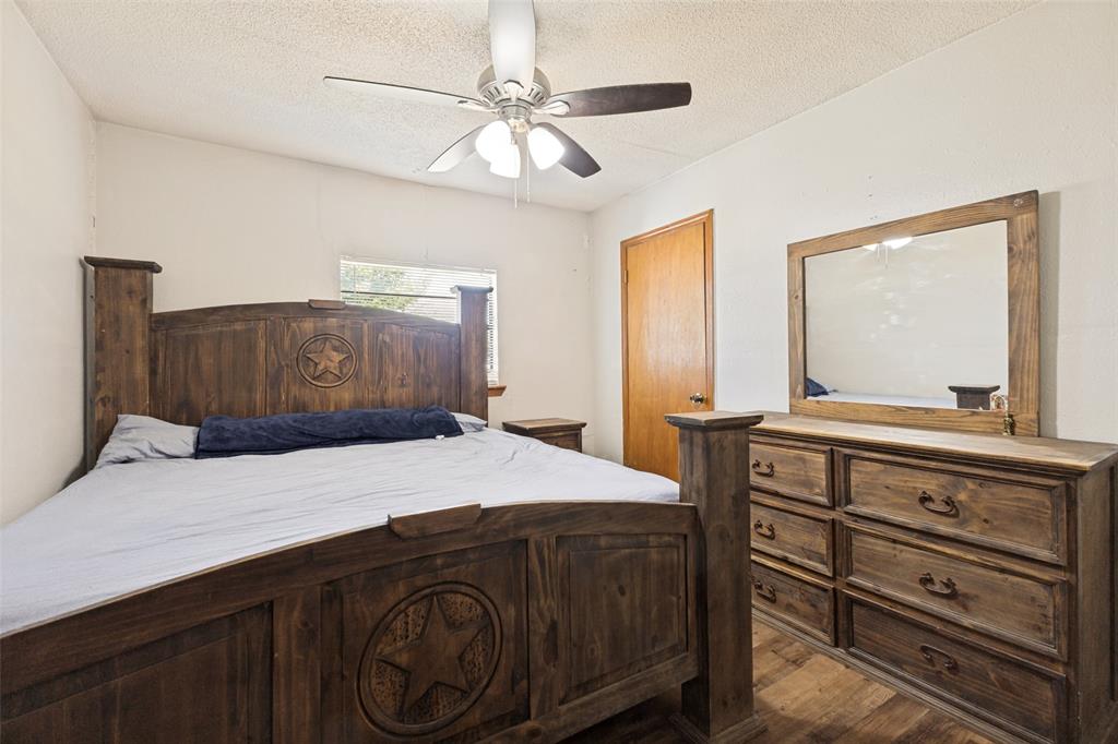 Wood-finish flooring, ceiling fan with integrated lighting, and solid core wood door