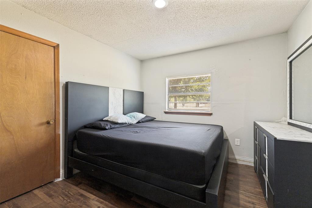 Wood-finish flooring, recessed lighting, and a single-pane horizontal window