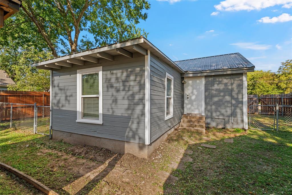 Exterior featuring horizontal lap siding, a metal roof, dual-pane windows, and a fenced backyard