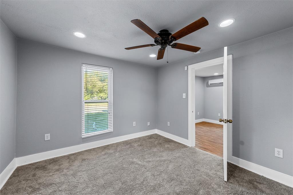 Interior room featuring neutral wall paint, recessed lighting, a ceiling fan with dark wood-finish blades, and carpeted flooring