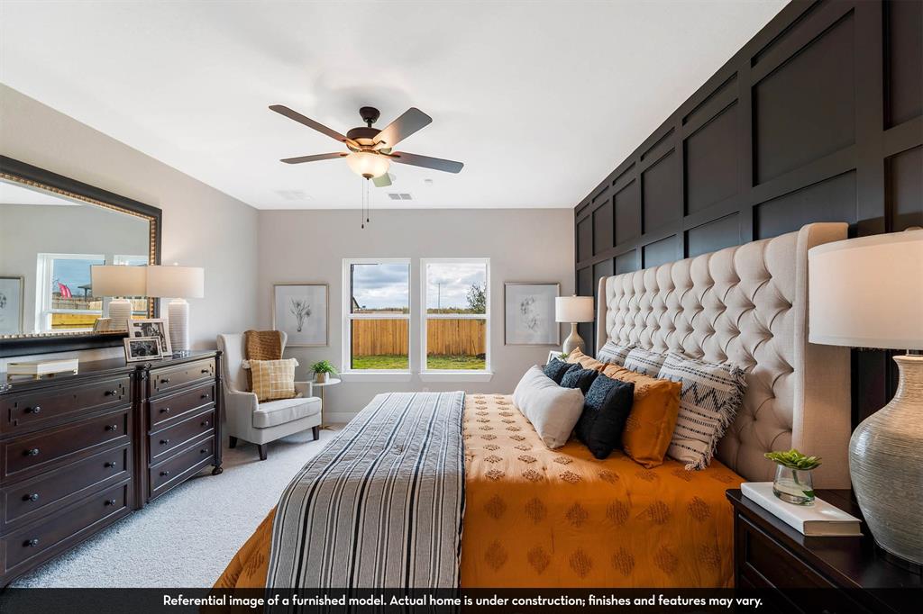 Dark-toned grid wainscoting accent wall, dual pane windows, and a ceiling-mounted light fixture with integrated fan