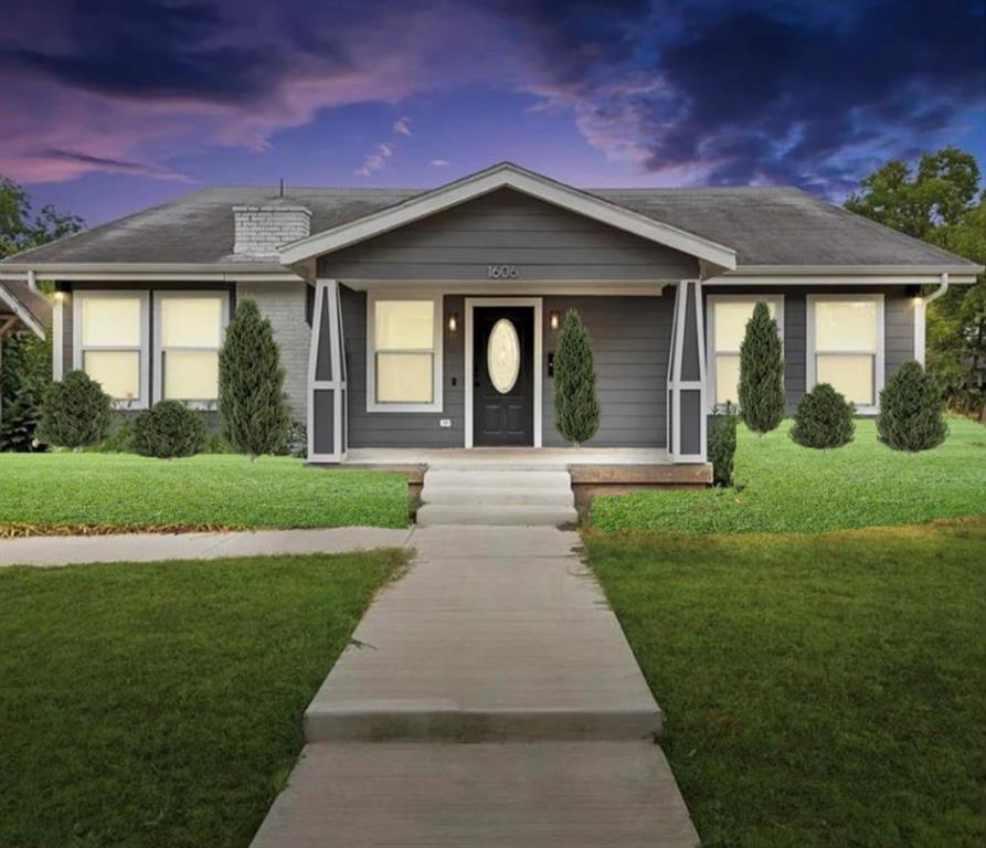 Single-story exterior featuring dark gray lap siding, a covered front porch with decorative columns, a painted brick chimney, and a central entryway with an oval glass insert door Single-story exterior featuring dark gray lap siding, a covered front porch with decorative columns, a painted brick chimney, and a central entryway with an oval glass insert door