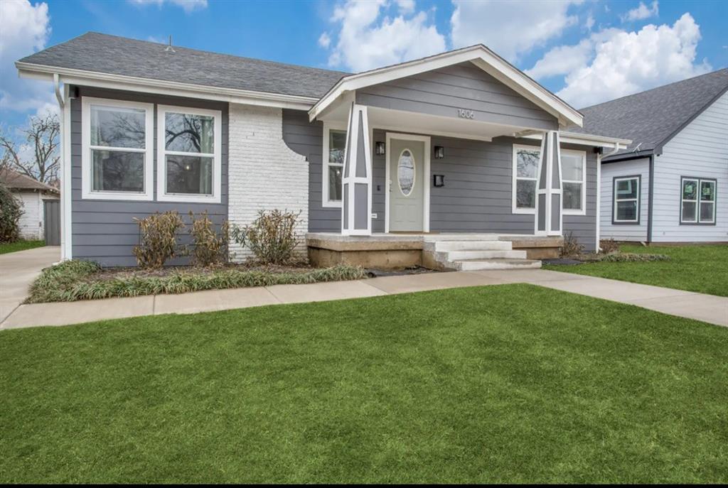 Exterior facade featuring gray lap siding, white brick accents, a covered front porch with tapered columns, and a concrete walkway Exterior facade featuring gray lap siding, white brick accents, a covered front porch with tapered columns, and a concrete walkway